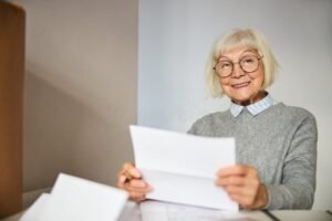pensionato sorridente con documenti in mano